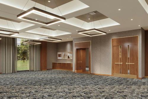 a large room with a large ballroom with wood paneling at AC Hotel by Marriott Newtown Square in Newtown Square