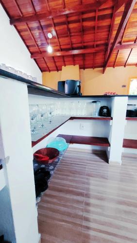 a kitchen with a sink and a counter top at Cantinho Dona Cleide in Monte Verde