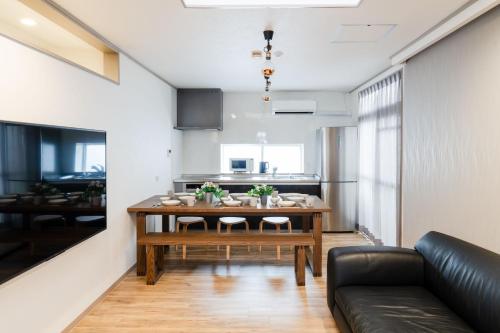 a living room with a table and a couch at グランシャーギ in Osaka