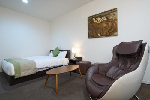 Postel nebo postele na pokoji v ubytování Hotel Tohkai