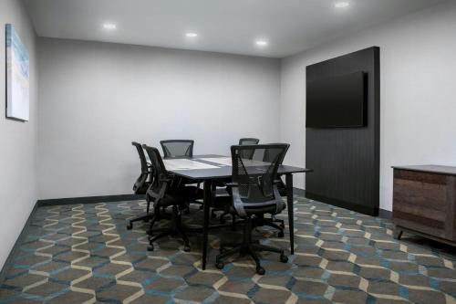 a conference room with a table and black chairs at Residence Inn by Marriott BWI Airport in Linthicum Heights
