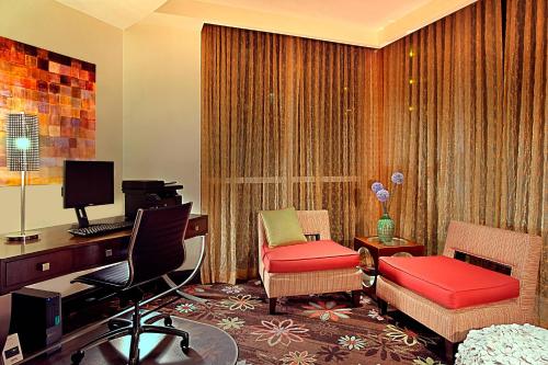 a room with a desk and two chairs and a computer at Residence Inn by Marriott St. Petersburg Treasure Island in St Pete Beach