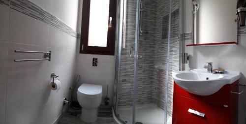 a bathroom with a toilet and a sink and a shower at Giorgia House in Pieta