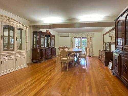 a living room with a table and a dining room at Granny Unit Self Contained Double Storage WIFI POOL PARKING in Templestowe