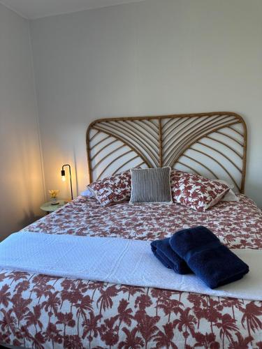 a bed with two pillows and a blue hat on it at Beach Bunker Scotts Head in Scotts Head