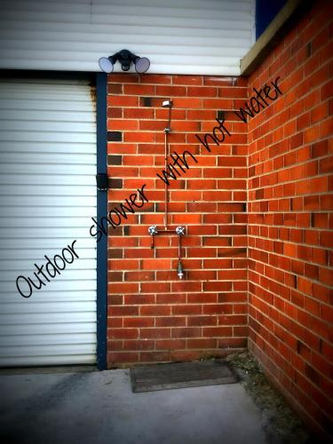 a brick wall with two garage doors with the words happy birthday at Beach Bunker Scotts Head in Scotts Head