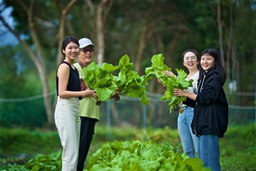 a group of people holding plants in a garden at Gaeavilla Resort in Jian