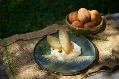 a blue plate with apples on it with a basket of eggs at Gaeavilla Resort in Jian