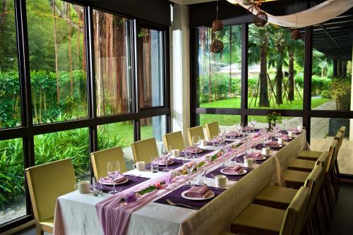 a long table in a room with windows at Gaeavilla Resort in Jian