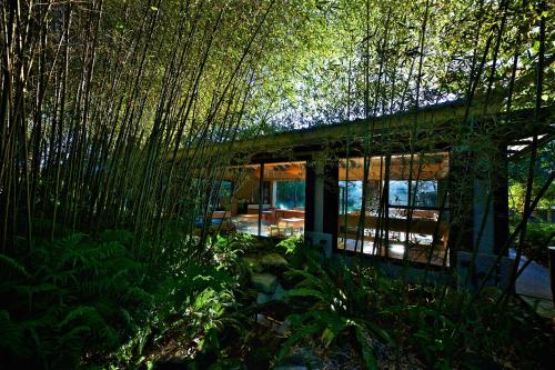 a bamboo house in the middle of a forest at Gaeavilla Resort in Jian