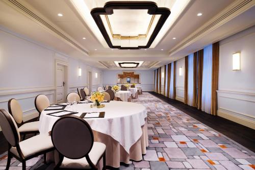 a conference room with tables and chairs and a ceiling at Hotel Bristol, A Luxury Collection Hotel, Warsaw in Warsaw