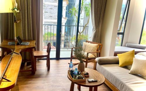 a living room with a couch and a table at Kim House Boutique Hotel Da Nang in Da Nang