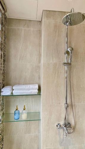 a shower with a glass shelf in a bathroom at Kim House Boutique Hotel Da Nang in Da Nang