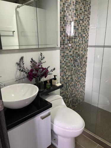 ein Badezimmer mit Waschbecken, Toilette und Dusche in der Unterkunft Confortable apartamento in Cali