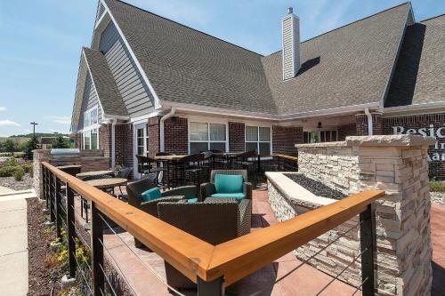 a deck with chairs and tables on a house at Residence Inn by Marriott Madison West/Middleton in Middleton