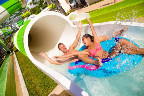 a man and a woman in a pool of water at Sandos Caracol Eco Resort All Inclusive in Playa del Carmen