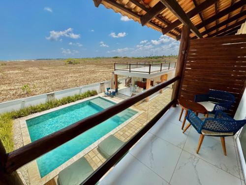 a view from the balcony of a house with a swimming pool at Caly Pousada in São Miguel do Gostoso