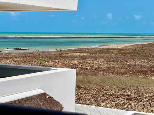 a view of the beach from a house at Caly Pousada in São Miguel do Gostoso