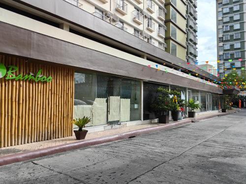 a store front of a building with potted plants at D&G City Haven in Mandaue City