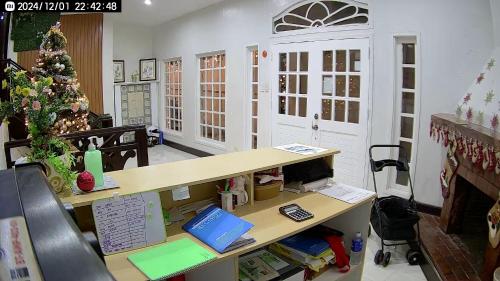 an office with a christmas tree and a desk at Baden Powell Hostel in Baguio