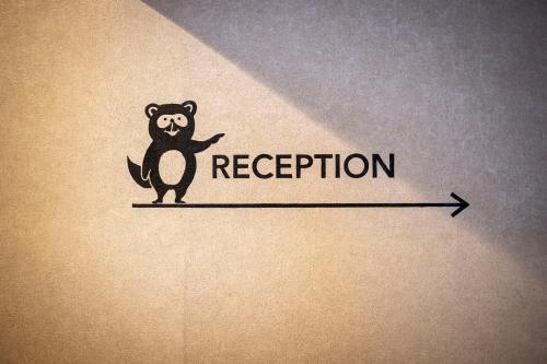 a drawing of a bear standing on a line with a regression line at Tanuki Nozawa in Nozawa Onsen