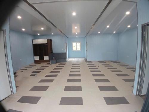 an empty room with blue walls and white floors at Halo Retreat in Hòa Bình