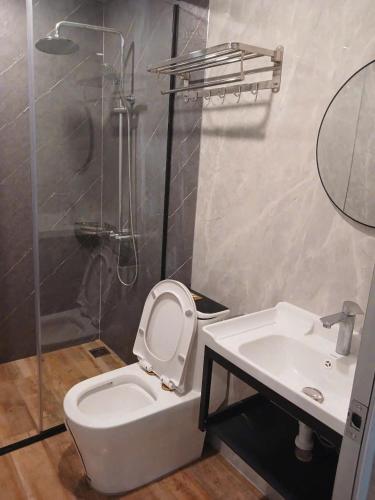 a bathroom with a toilet and a sink and a shower at Halo Retreat in Hòa Bình