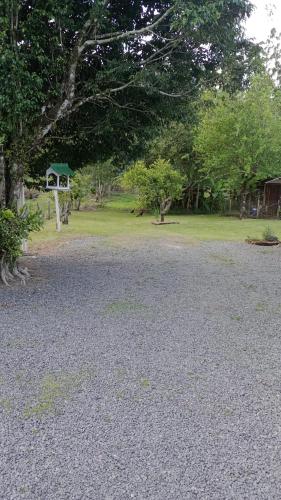 a gravel parking lot with a gazebo in a park at Cantinho aconchegante in Timbó