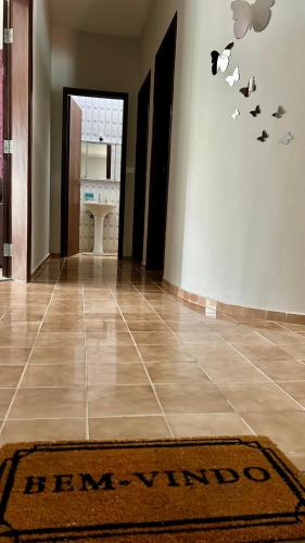 a hallway with a floor with a rug on the floor at Casa com excelente localização! in São Roque