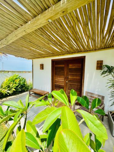 an outdoor patio with a wooden pergola at Casa Calango suites in Fortim