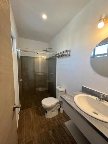 a bathroom with a toilet and a sink at Casa Japandi in Manta
