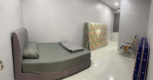 a small bed sitting in a room with at YY Palace Pagoh Jaya in Pagoh