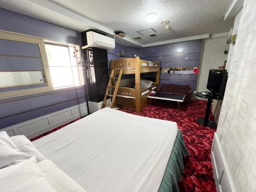 a bedroom with a bed and a bunk bed at Hotel 21 in Nagasaki