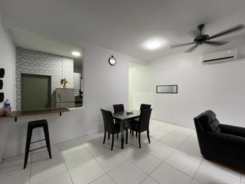 a dining room with a table and black chairs at EL Homestay in Melaka