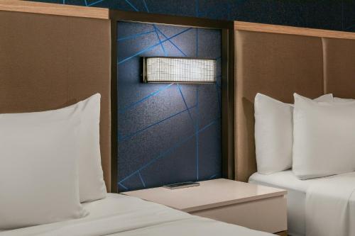 two beds with white pillows and a window in a room at SpringHill Suites Denver North / Westminster in Westminster