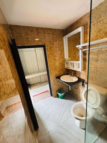 a bathroom with a toilet and a sink at Vang Vieng Rivercube Hotel in Vang Vieng