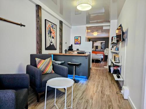 a living room with a couch and a table at Place des Arts by Hébergements DCL in Quebec City