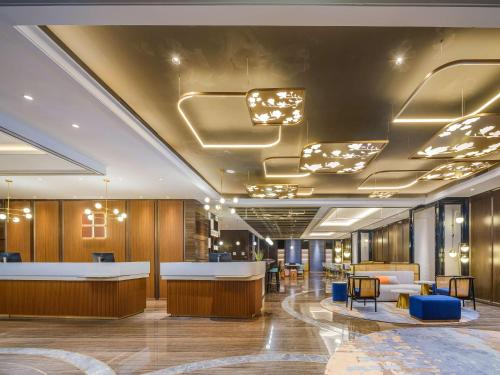 an office lobby with a reception desk and chairs at Hilton Garden Inn Beijing Guomao in Beijing