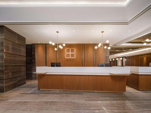 an office lobby with wood paneling and a reception desk at Hilton Garden Inn Beijing Guomao in Beijing