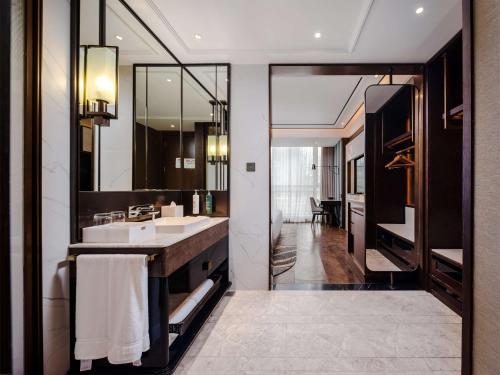 a bathroom with a sink and a mirror at Hilton Garden Inn Beijing Guomao in Beijing