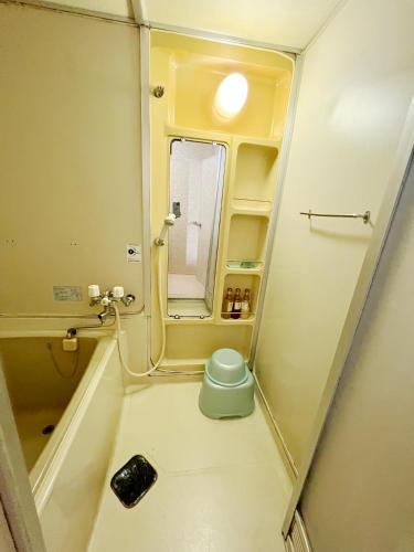 a small bathroom with a toilet and a mirror at Hotel 21 in Nagasaki