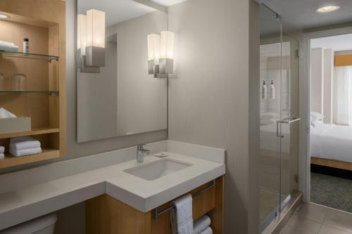 a bathroom with a sink and a shower at Delta Hotels by Marriott Whistler Village Suites in Whistler