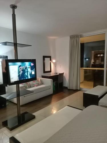 a living room with a couch and a flat screen tv at Playa Blanca in Playa Blanca