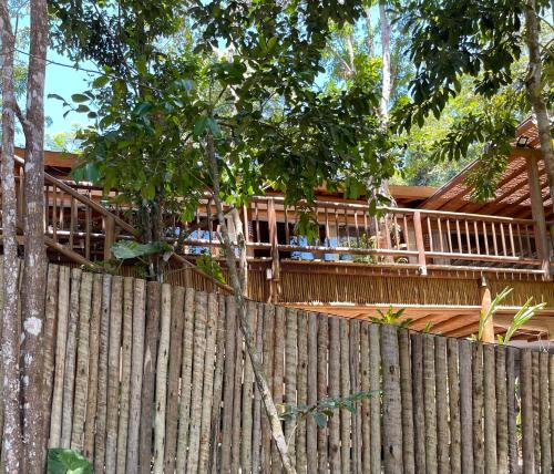 a wooden fence in front of a house at CASA PREGUIÇA - TRANCOSO - ECO in Trancoso