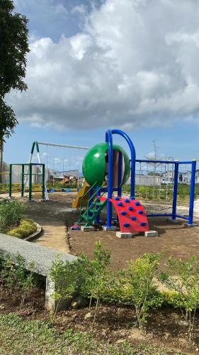 a playground in a park with a play equipment at Migs&Lucia NewNew House in Tagaytay and Caleruega in Calo