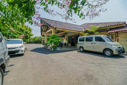 a white van parked in front of a building at Urbanview Hotel Cendrawasih Lahat By RedDoorz in Muaraenim