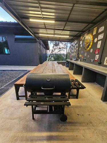 a table with a grill sitting on top of it at Black Sheep House Khaoyai by ALPHATEL PARTNER in Pong Talong