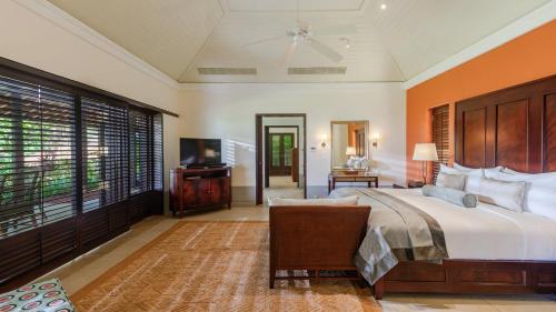 a bedroom with a large bed and a television at Cape Weligama - Relais and Chateaux in Weligama