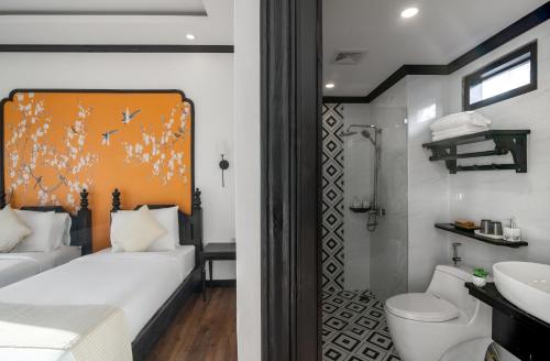 a bathroom with a bed and a toilet and a sink at Luang Prabang Vang Luang Hotel in Luang Prabang