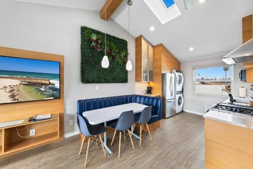 a kitchen and dining room with a table and chairs at Modern Luxury 2BR Apt in Heart of Ocean Beach in San Diego